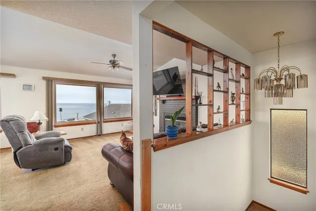 a living room with furniture and large windows