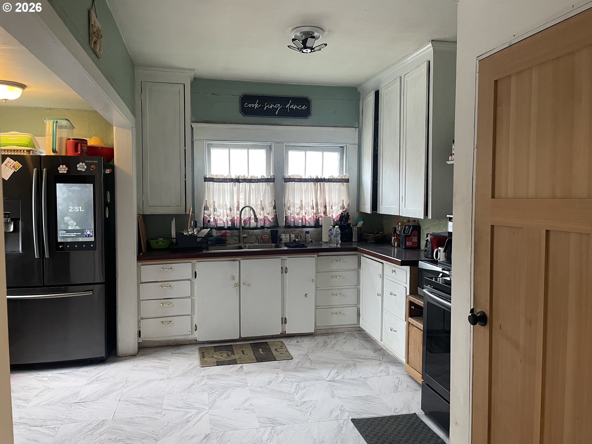 1006 5th Street Springfield, OR 97477 - Photo 11 of 43 a kitchen with a refrigerator and cabinets