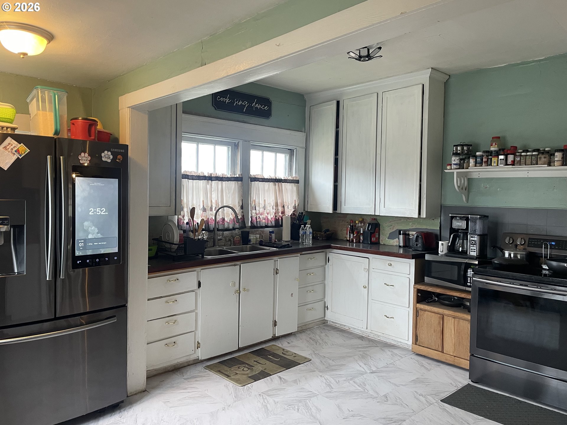 1006 5th Street Springfield, OR 97477 - Photo 13 of 43 a kitchen with granite countertop a refrigerator stove and sink