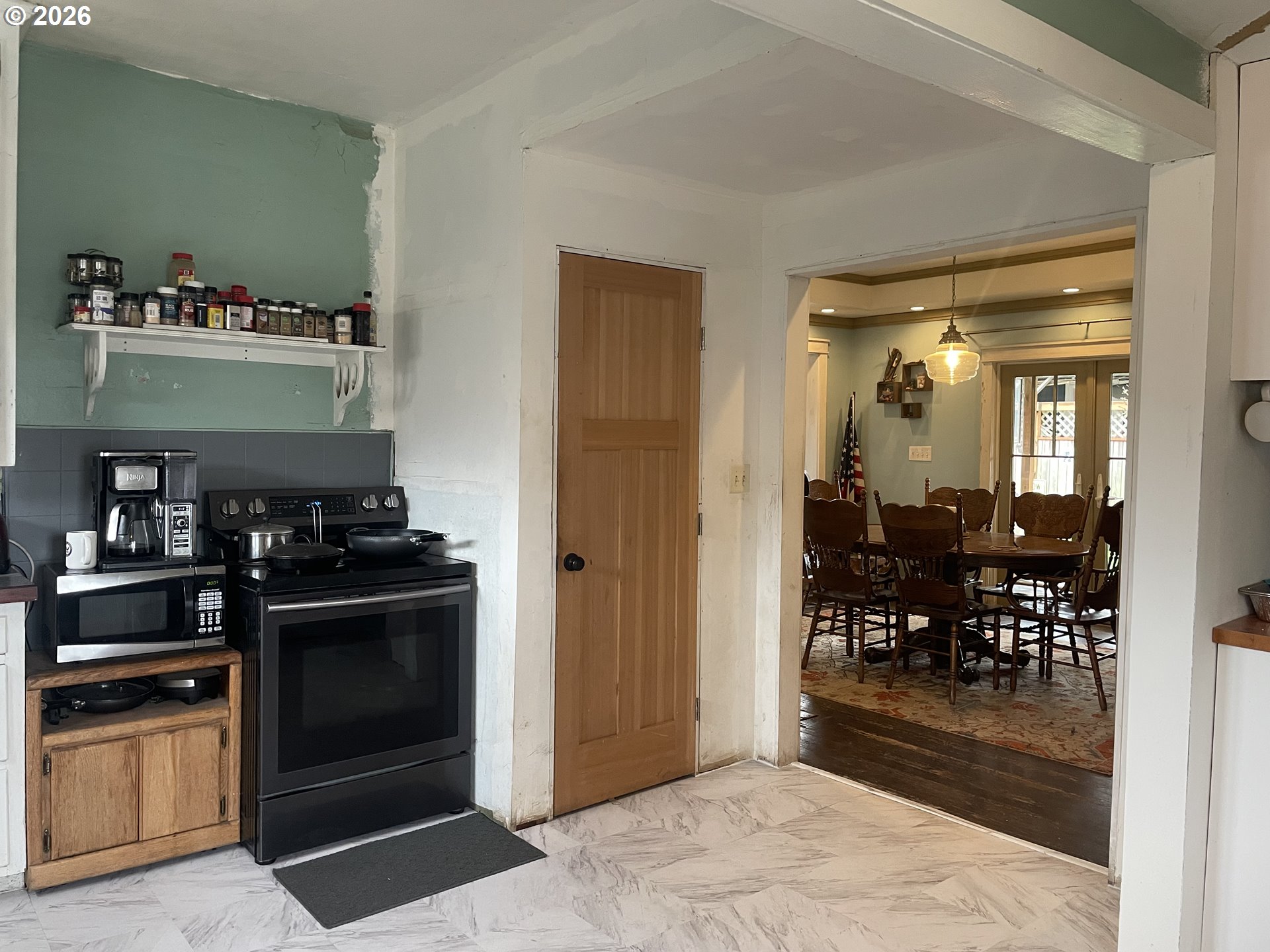 1006 5th Street Springfield, OR 97477 - Photo 18 of 43 a kitchen with granite countertop a refrigerator and a stove top oven