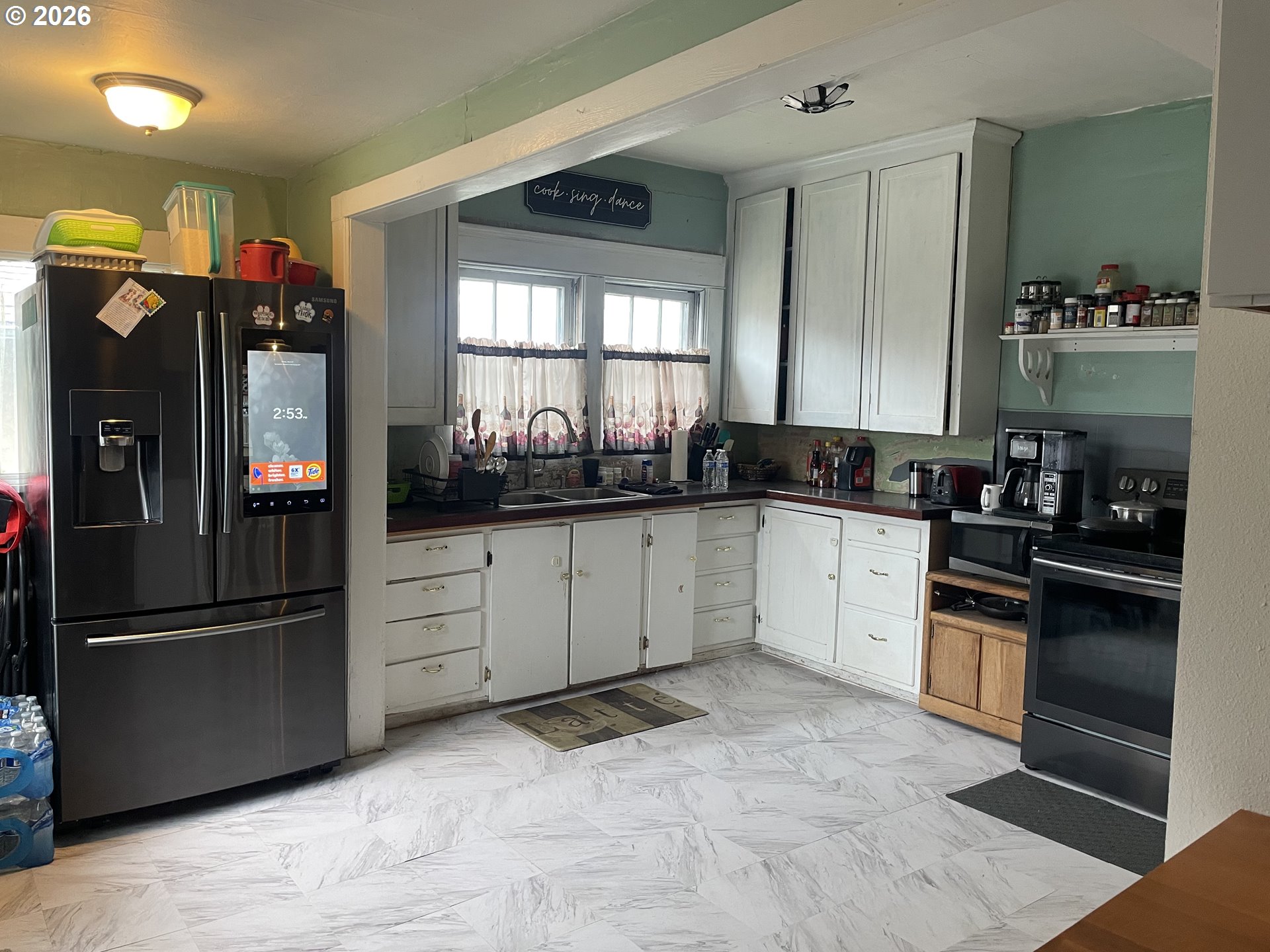 1006 5th Street Springfield, OR 97477 - Photo 21 of 43 a kitchen with granite countertop a refrigerator and a sink