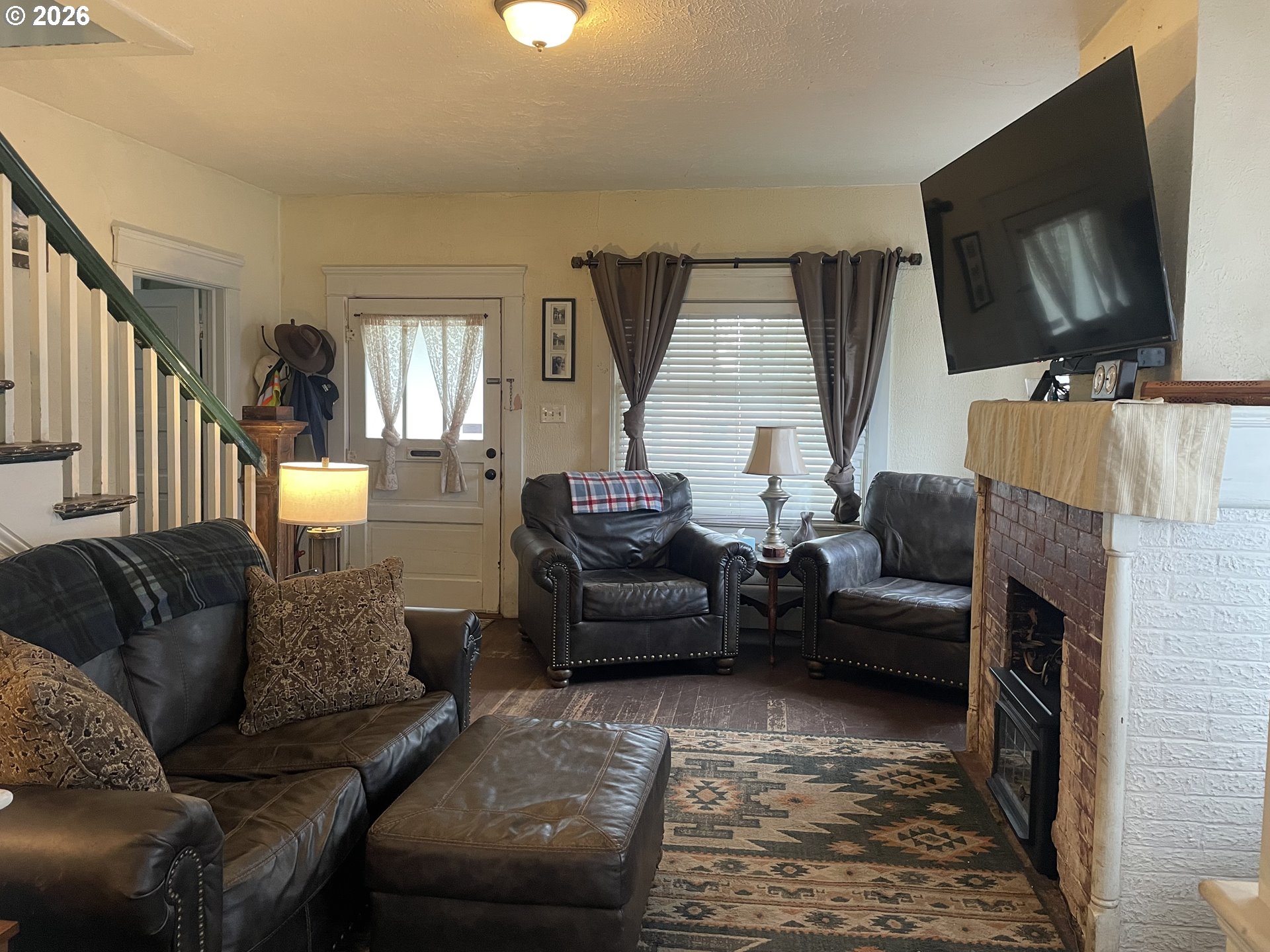 1006 5th Street Springfield, OR 97477 - Photo 4 of 43 a living room with furniture and a flat screen tv