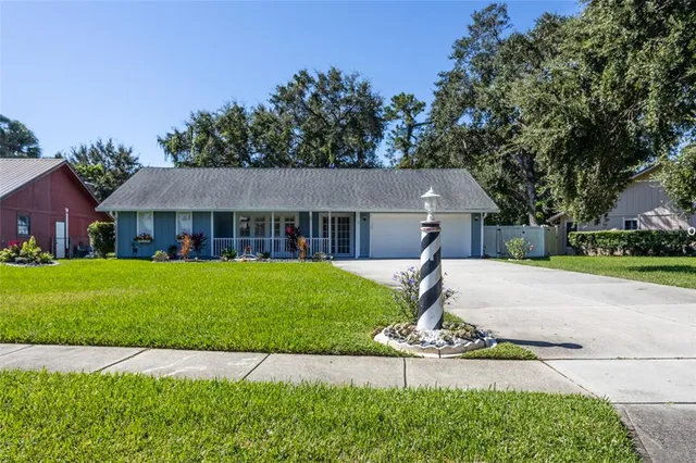 a front view of house with yard and green space