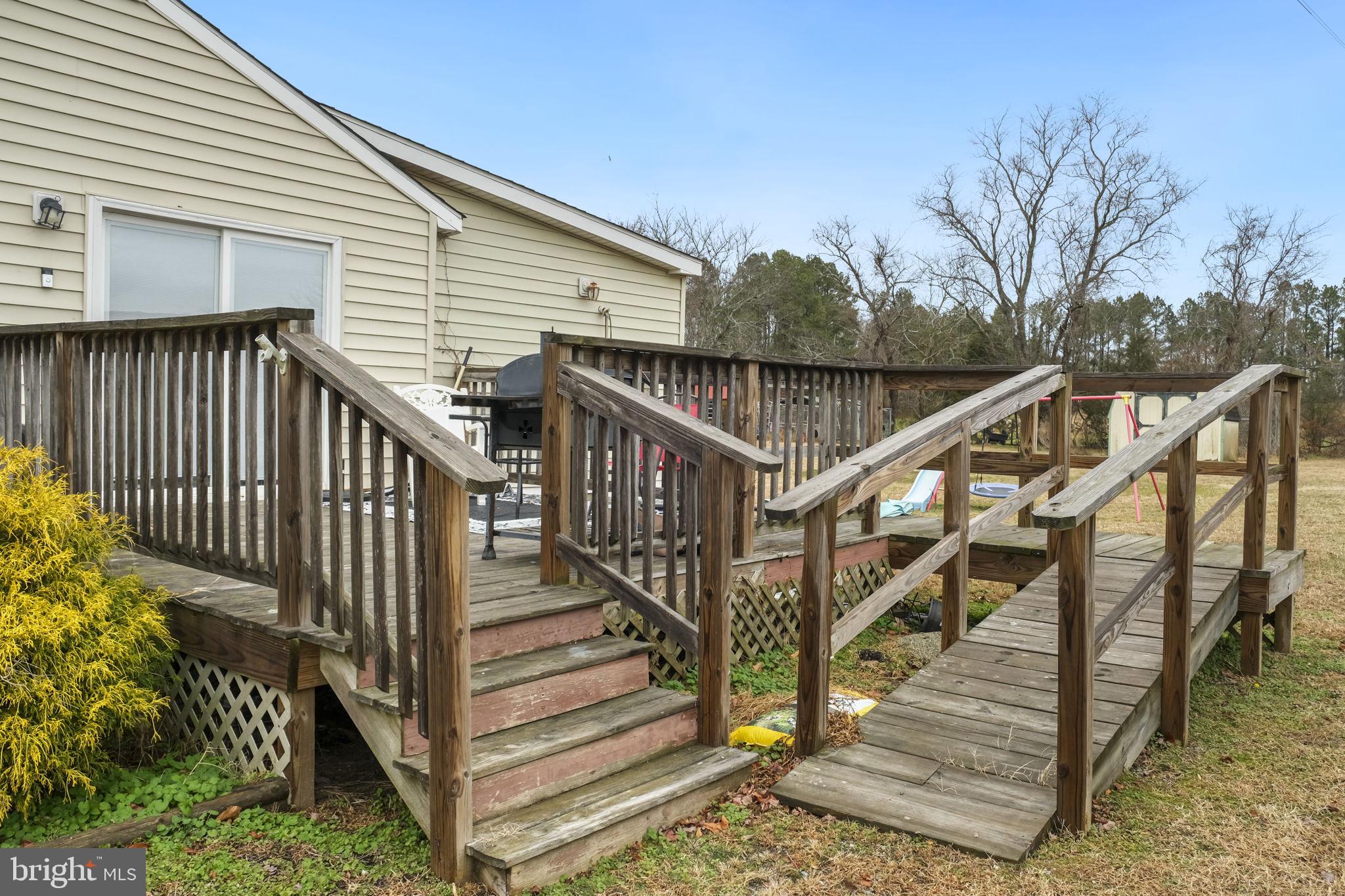 335 Bells Drive Warsaw, VA 22572 - Photo 2 of 11 a view of wooden house with a stairs