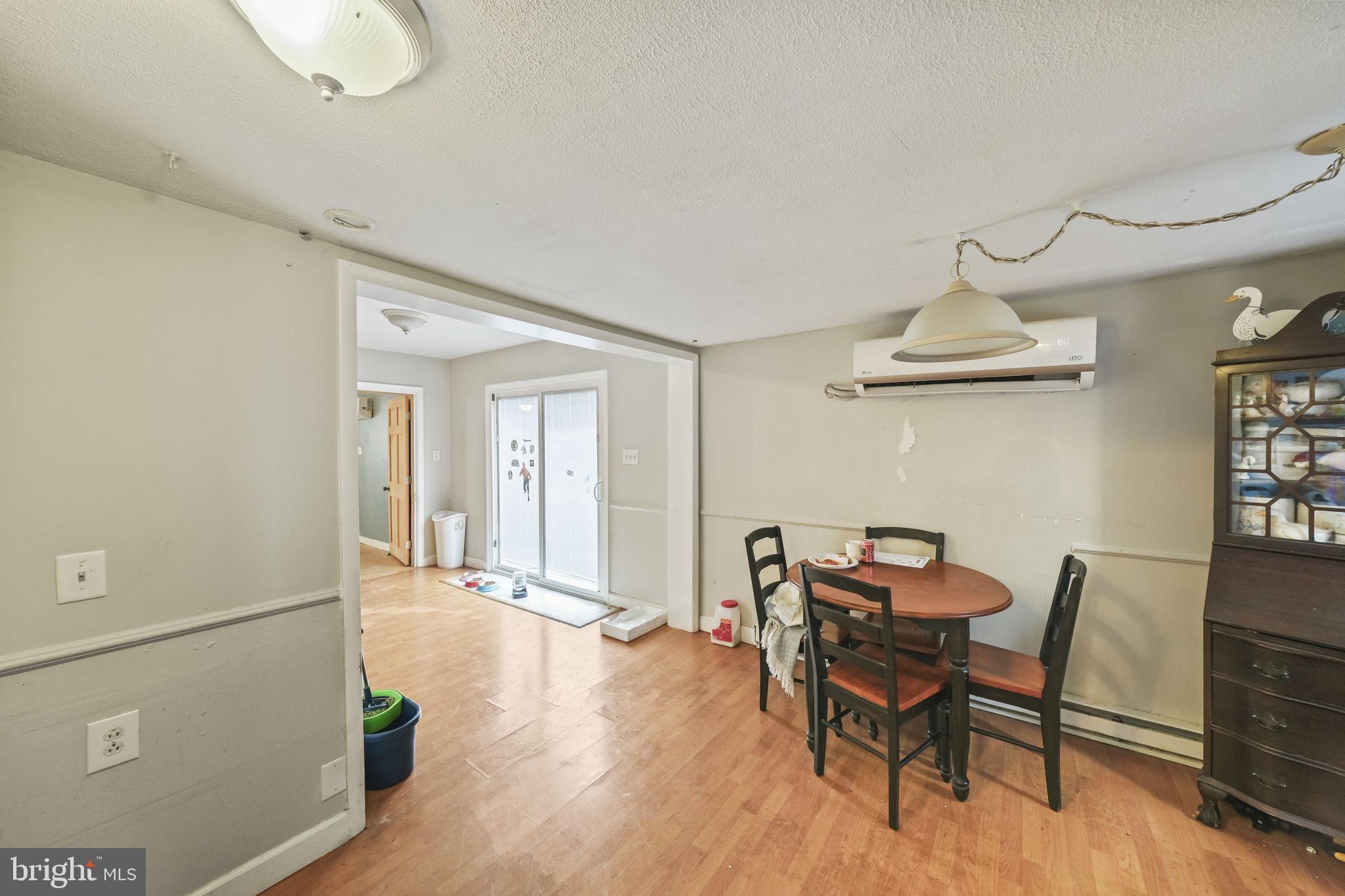 335 Bells Drive Warsaw, VA 22572 - Photo 3 of 11 a view of a dining room with furniture and wooden floor