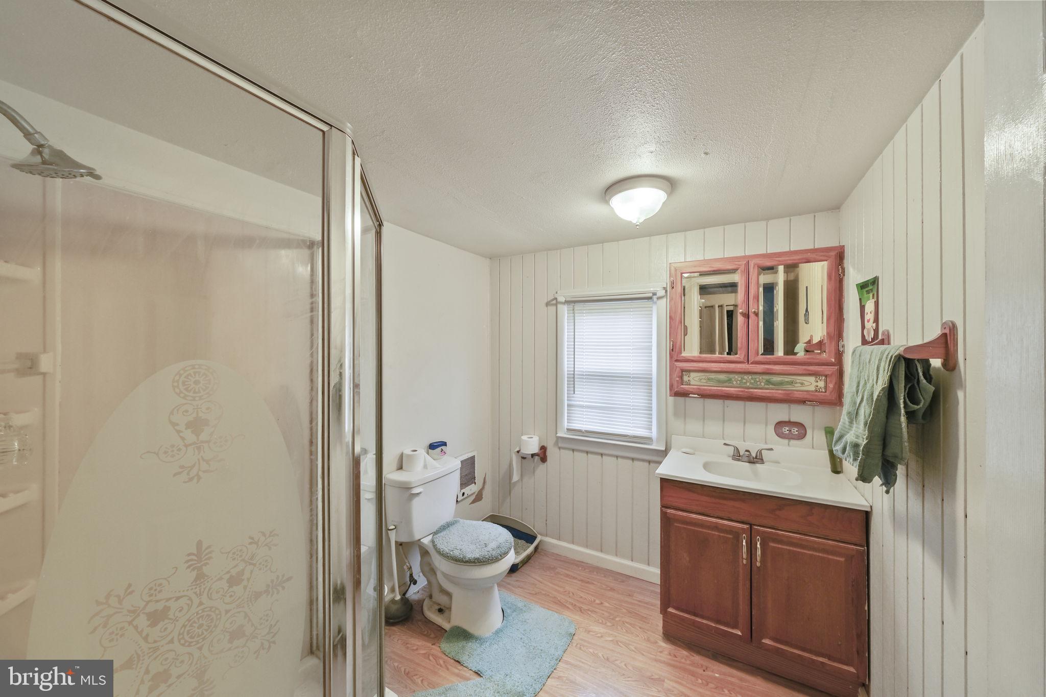 335 Bells Drive Warsaw, VA 22572 - Photo 6 of 11 a bathroom with a toilet sink and mirror