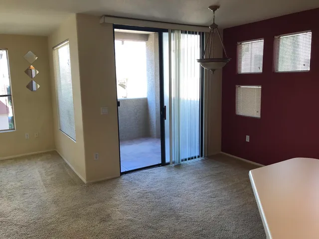 an empty room with windows and closet