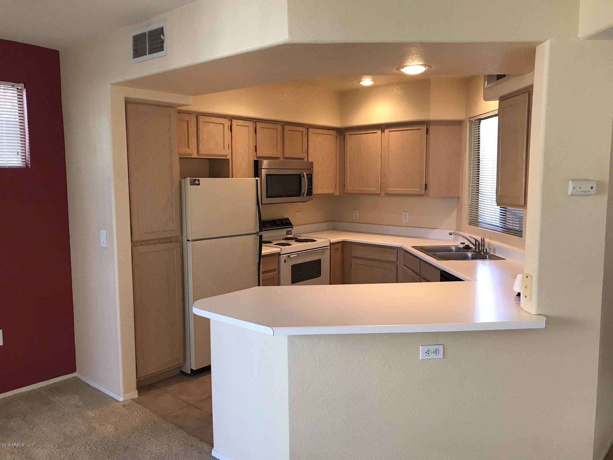 3848 North 3rd Avenue, Unit 2046 Phoenix, AZ 85013 - Photo 13 of 25 a kitchen with a refrigerator and a sink