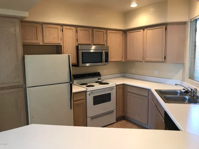 a kitchen with a refrigerator sink and microwave
