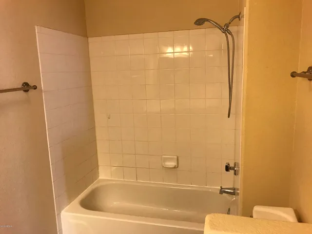 a bathroom with a bathtub and shower