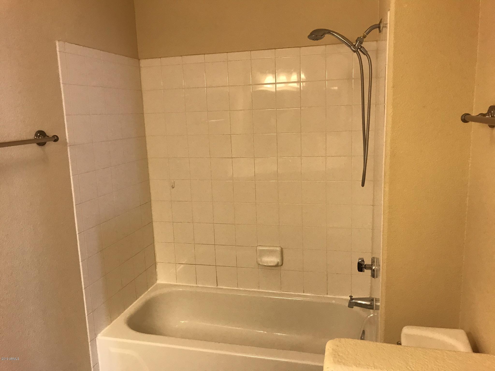 3848 North 3rd Avenue, Unit 2046 Phoenix, AZ 85013 - Photo 21 of 25 a bathroom with a bathtub and shower