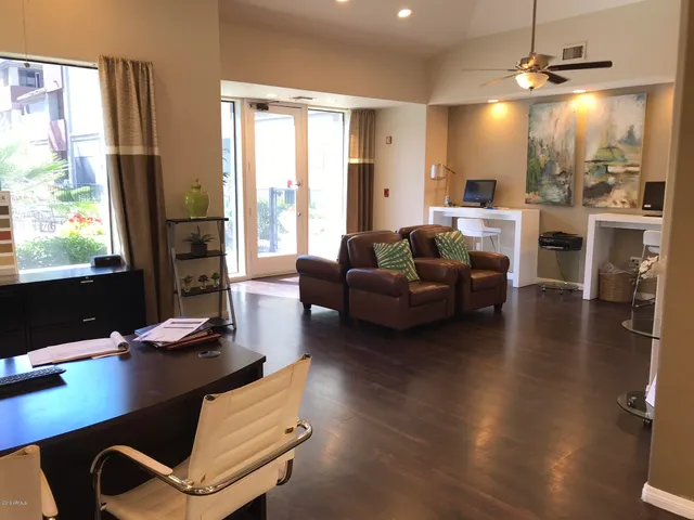 a living room with furniture a flat screen tv and a large window