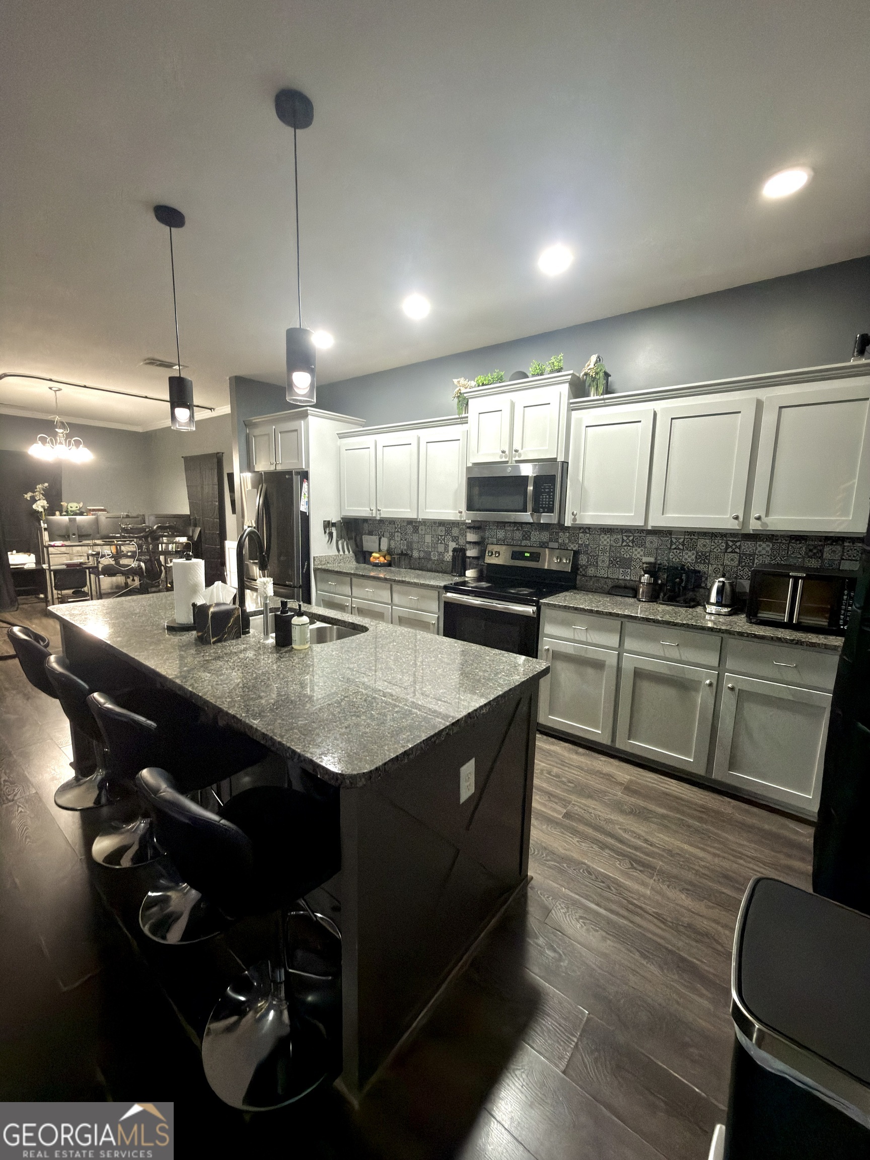 1615 Colony Lane Brooklet, GA 30415 - Photo 14 of 36 a kitchen with kitchen island granite countertop a sink appliances and cabinets