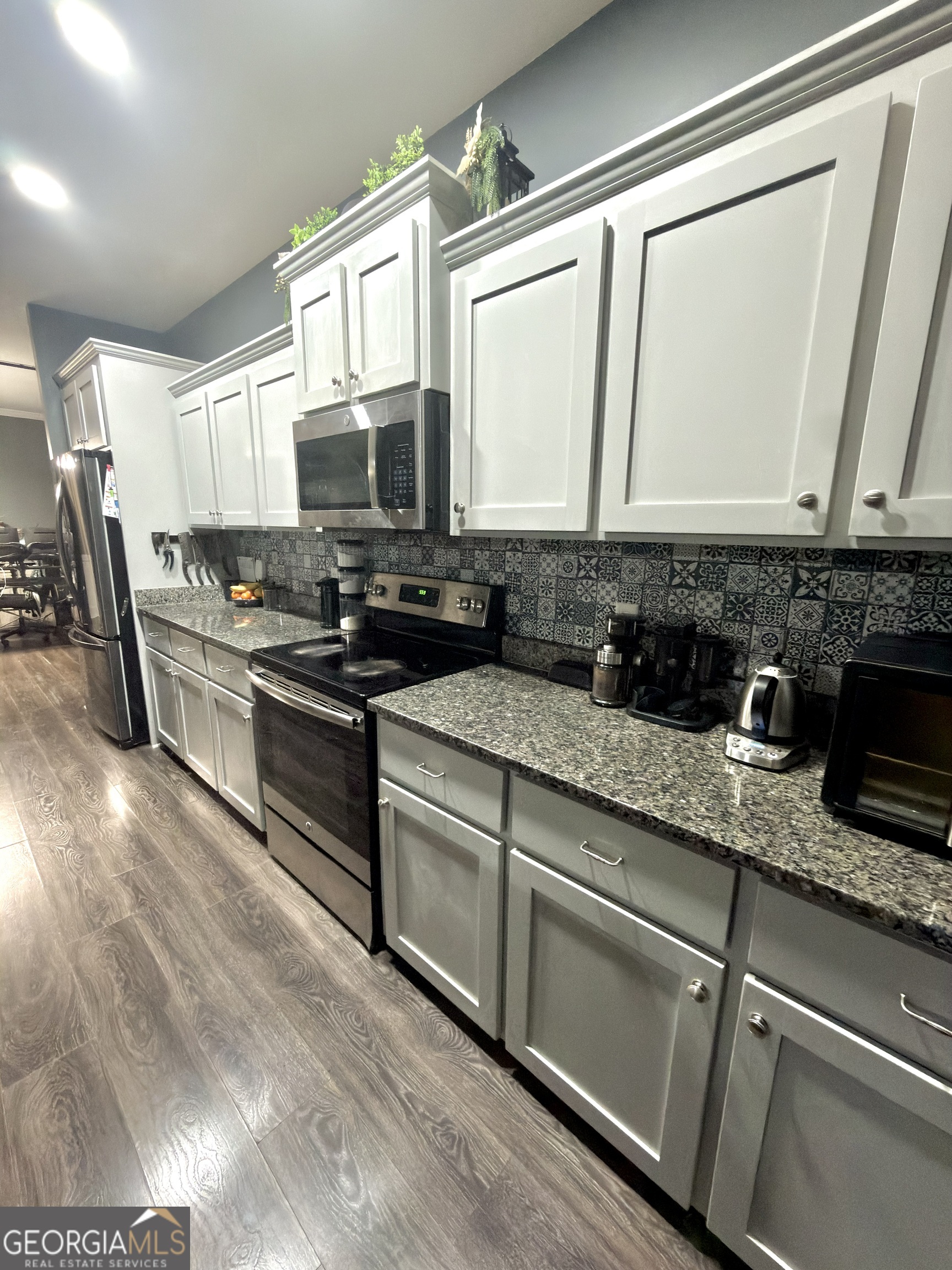 1615 Colony Lane Brooklet, GA 30415 - Photo 15 of 36 a kitchen with stainless steel appliances granite countertop a sink stove and cabinets