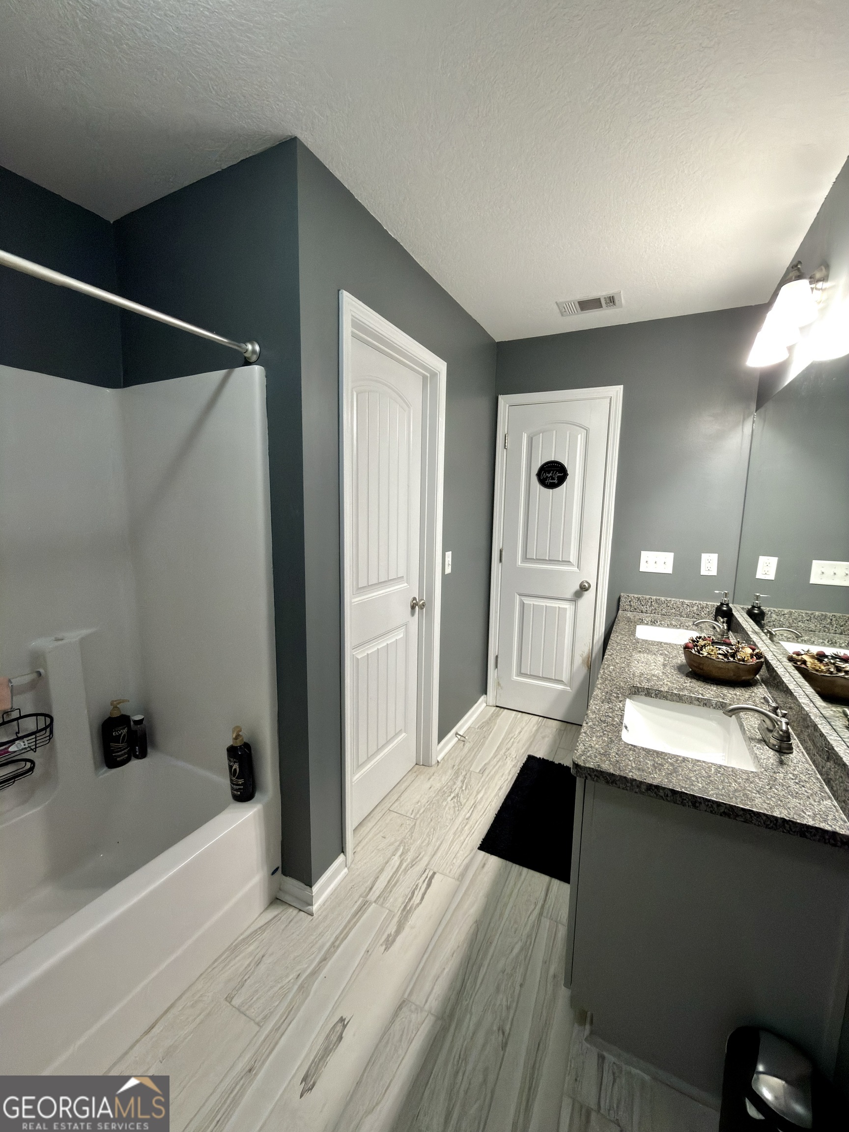 1615 Colony Lane Brooklet, GA 30415 - Photo 23 of 36 a spacious bathroom with a double vanity sink and a mirror