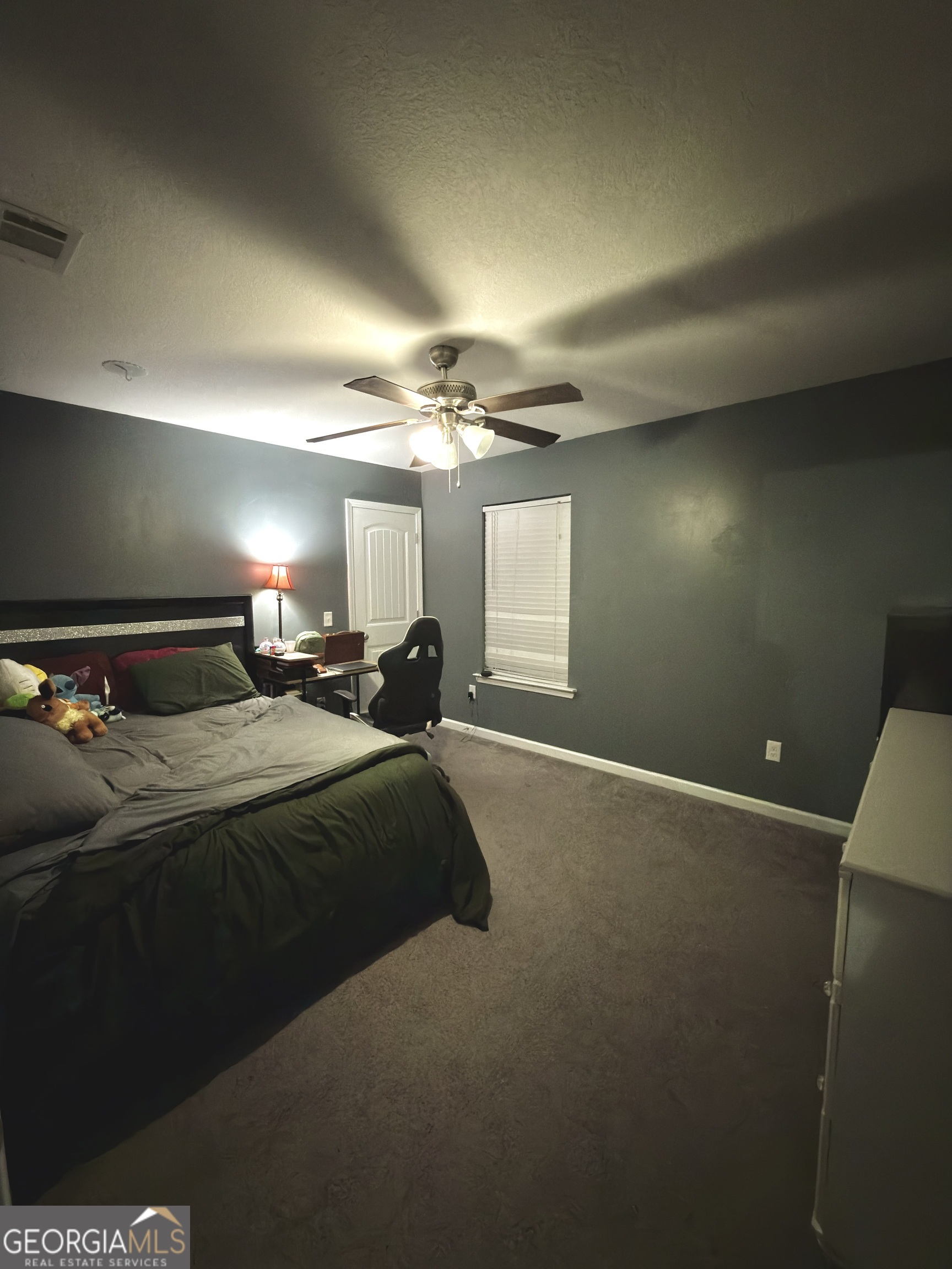 1615 Colony Lane Brooklet, GA 30415 - Photo 35 of 36 a spacious bedroom with a bed and a chandelier