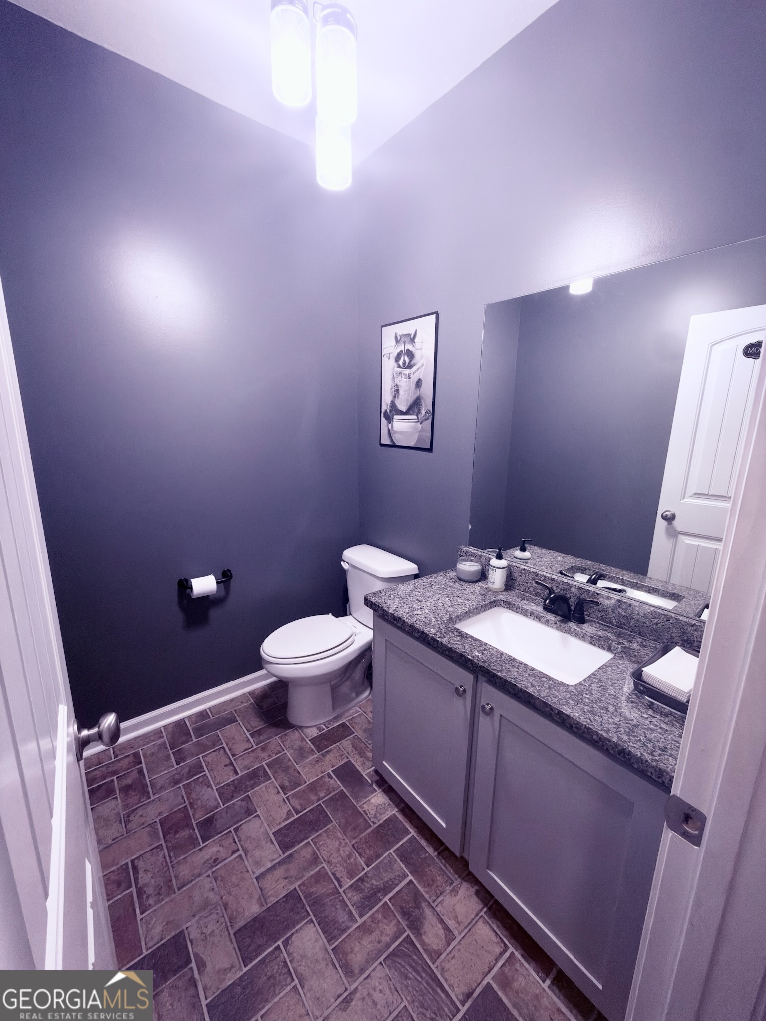 1615 Colony Lane Brooklet, GA 30415 - Photo 36 of 36 a bathroom with a granite countertop sink a mirror and a toilet