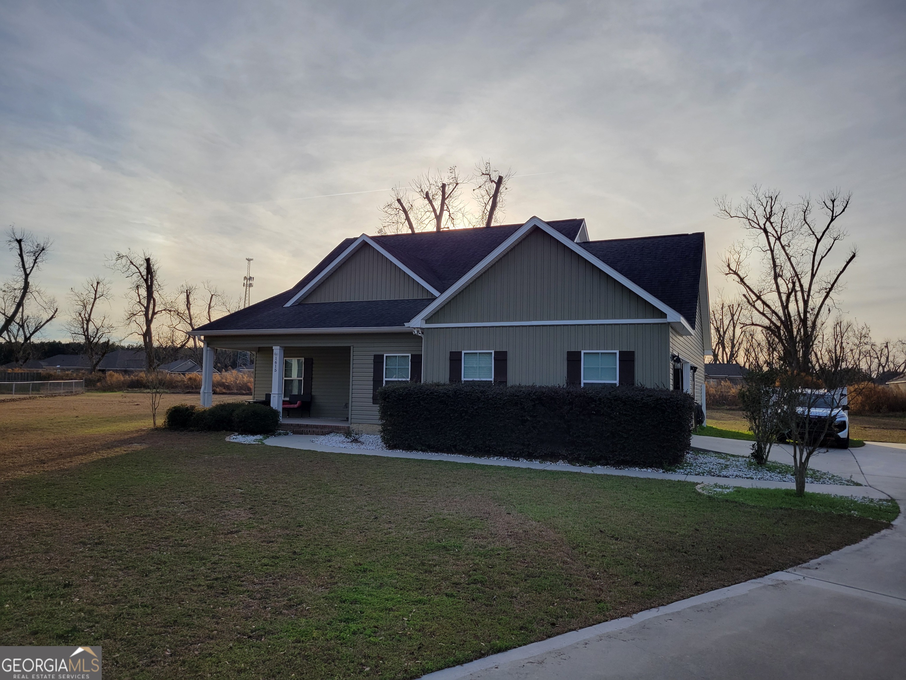 1615 Colony Lane Brooklet, GA 30415 - Photo 4 of 36 a front view of a house with a garden and yard