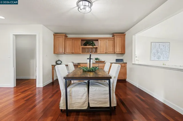 a dining room with furniture and wooden floor