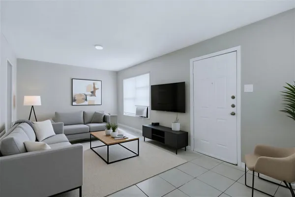 a living room with furniture and a flat screen tv