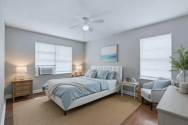 a bedroom with a bed couch and a window