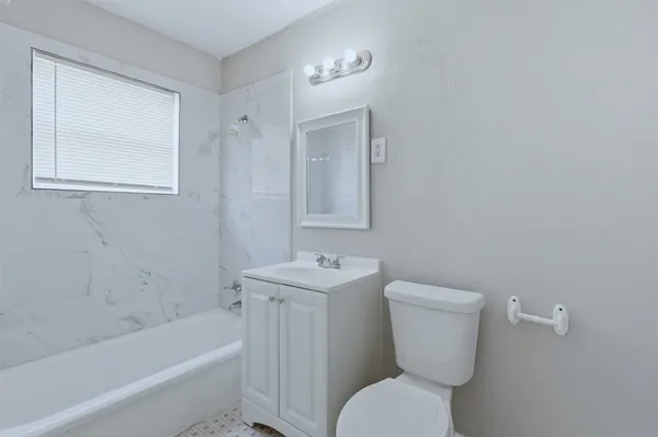 a bathroom with a toilet a sink and bathtub