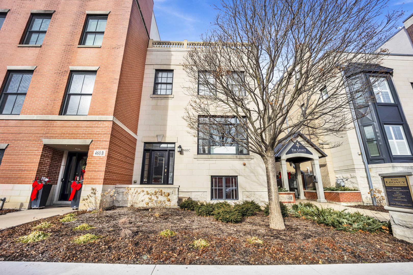 460 Pennsylvania Avenue, Unit C Glen Ellyn, IL 60137 - Photo 2 of 37 a view of a white house with a large tree