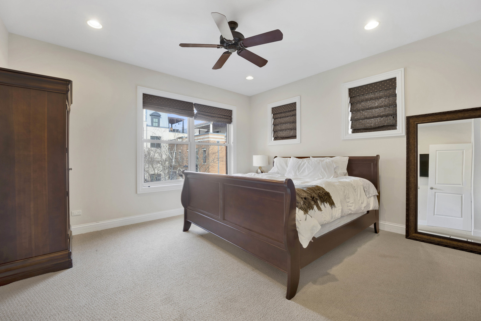 460 Pennsylvania Avenue, Unit C Glen Ellyn, IL 60137 - Photo 23 of 37 a bed room with a bed and a ceiling fan