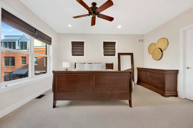 a bed room with a bed and painting on the wall