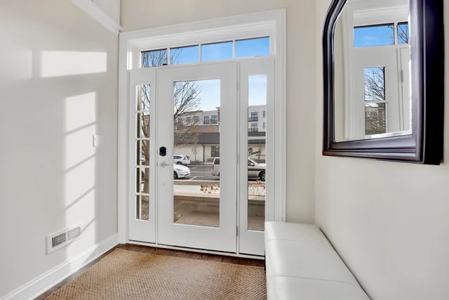 a view of a hallway with bathroom and front door