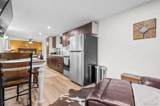 a kitchen with stainless steel appliances granite countertop a refrigerator and a stove top oven