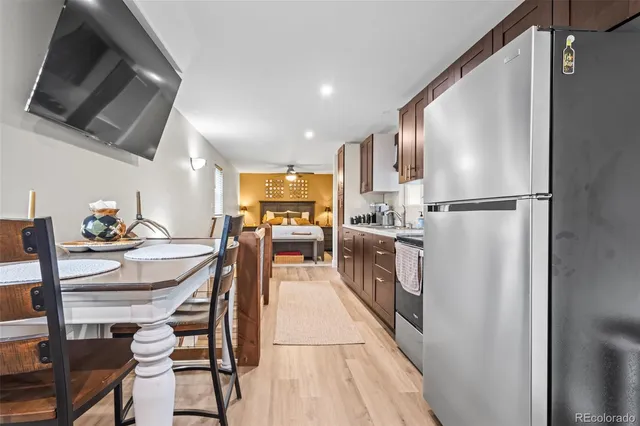 a kitchen with kitchen island a counter top space a sink stainless steel appliances and cabinets