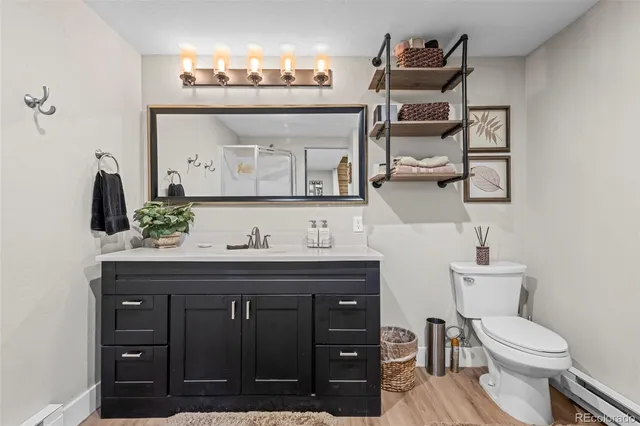 a bathroom with a toilet a sink and mirror