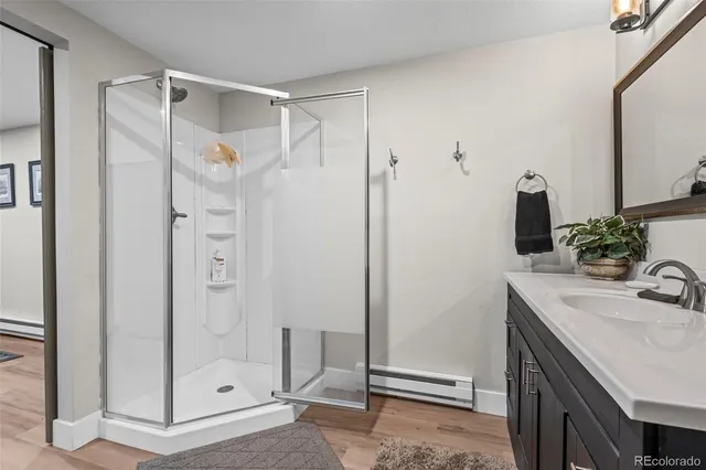 a bathroom with a shower sink and mirror