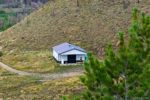 a yellow and red house with a yard