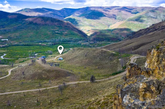 a backyard of a house with a yard and mountain view in back