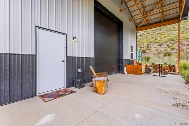 a bedroom with a bed and chairs
