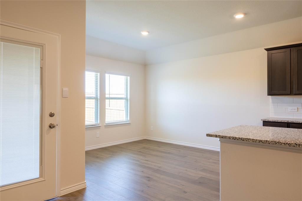 419 Revolution Road Fate, TX 75087 - Photo 4 of 19 a room with a bed and a flat screen tv