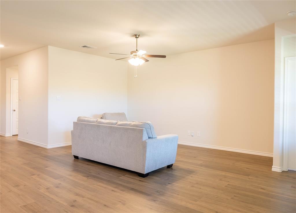 419 Revolution Road Fate, TX 75087 - Photo 6 of 19 a living room with furniture and a ceiling fan