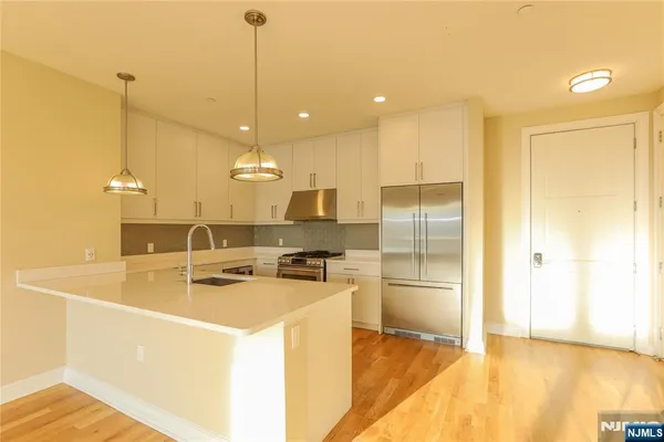 a view of a kitchen with a sink and cabinets