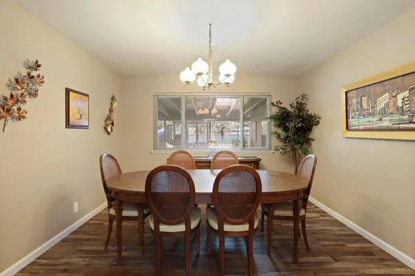 a view of a dining room with furniture wooden floor and a chandelier