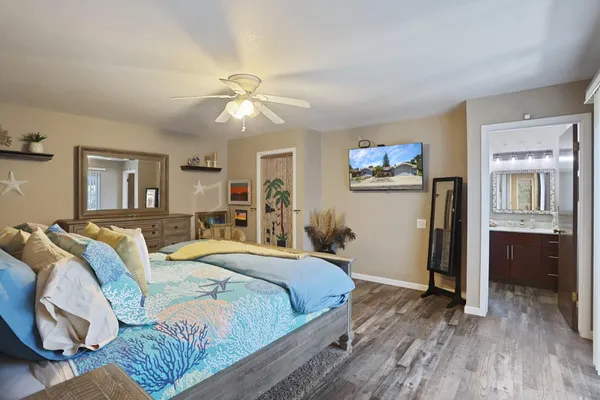 a bedroom with a bed and wooden floor