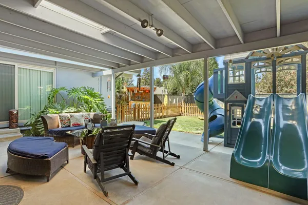 a building outdoor space with patio furniture and potted plants