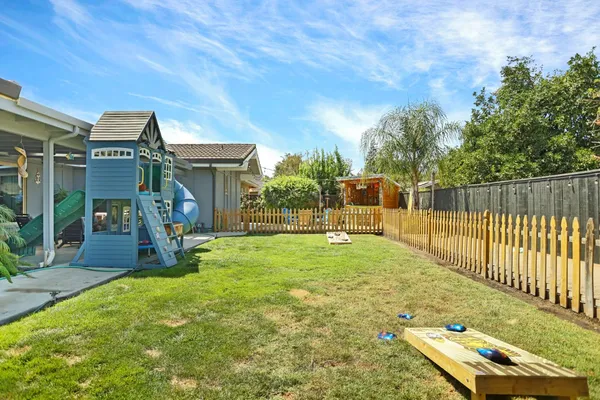 a view of a house with backyard and porch