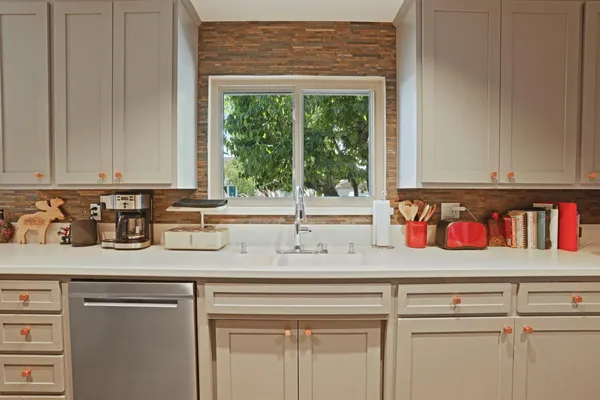a kitchen with a sink and a window