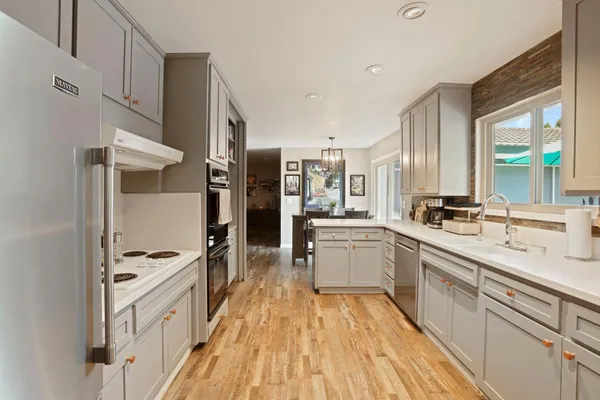 a kitchen with stainless steel appliances a refrigerator sink and stove