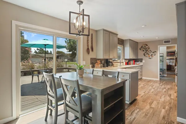 a kitchen with stainless steel appliances granite countertop a stove top oven a sink island and a refrigerator