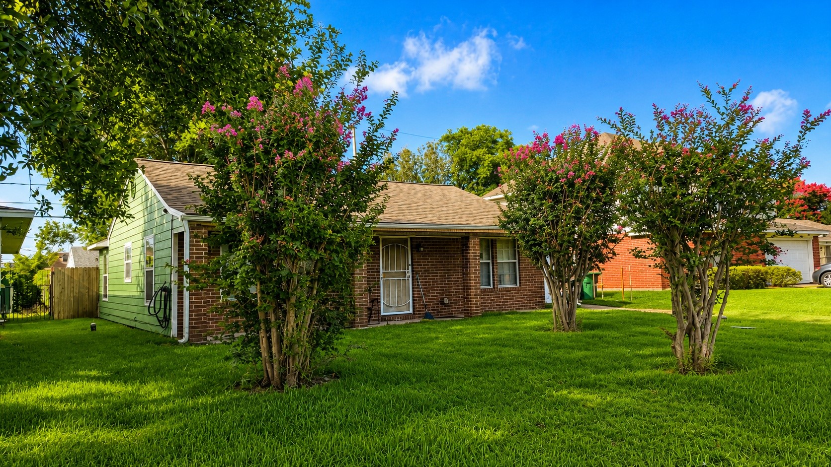 7622 Azalea Street Houston, TX 77023 - Photo 2 of 10 Charming brick exterior nestled among mature landscaping and a spacious front yard.