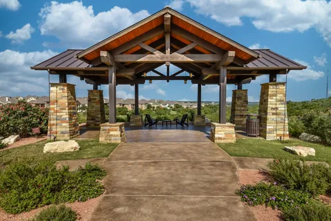 a view of a patio with table and chairs under an umbrella