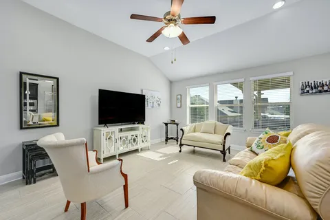 a living room with furniture and a flat screen tv
